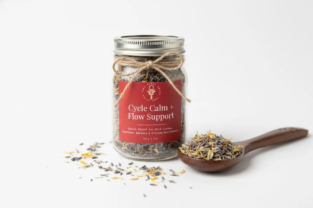 Jar of 'Cycle Calm + Flow Support' with dried herbs on a white background