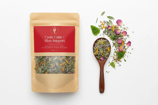 Tea package labeled 'Cycle Calm + Flow Support' with a wooden spoon of tea leaves on a white background