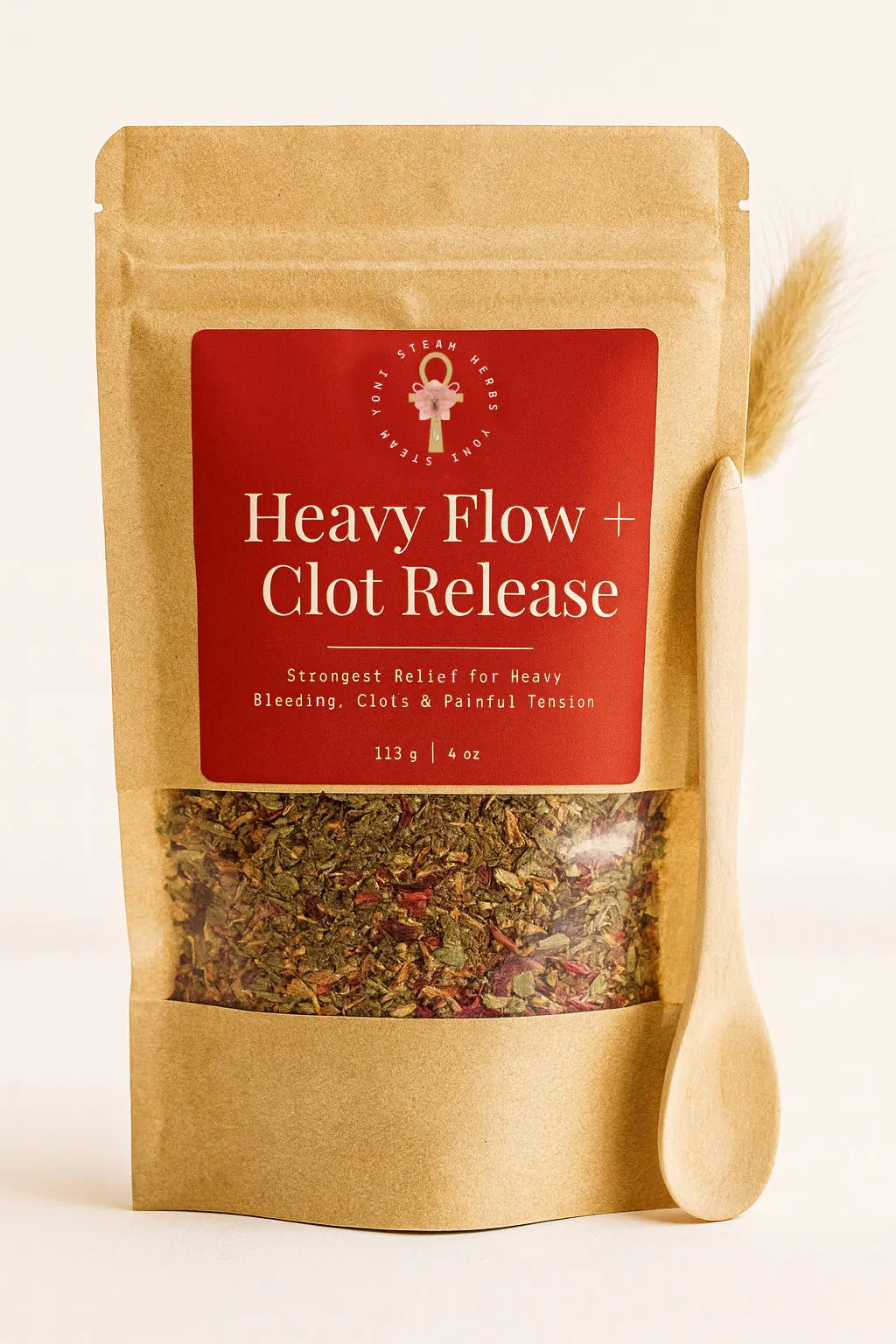 Tea package labeled 'Heavy Flow Clot Release' with a wooden spoon on a beige background