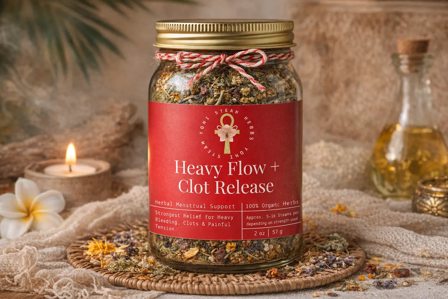 Jar of 'Heavy Flow + Clot Release' with a red label on a textured surface with flowers and candles.
