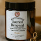 Jar of 'Postpartum Sacred Renewal' herbal healing balm with a label on a wooden surface.
