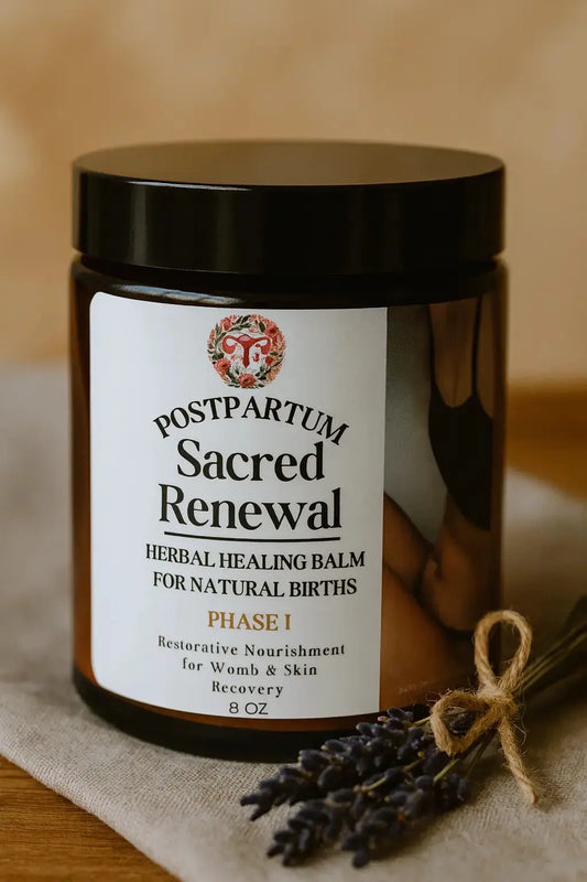 Jar of 'Postpartum Sacred Renewal' herbal healing balm with a label on a wooden surface.